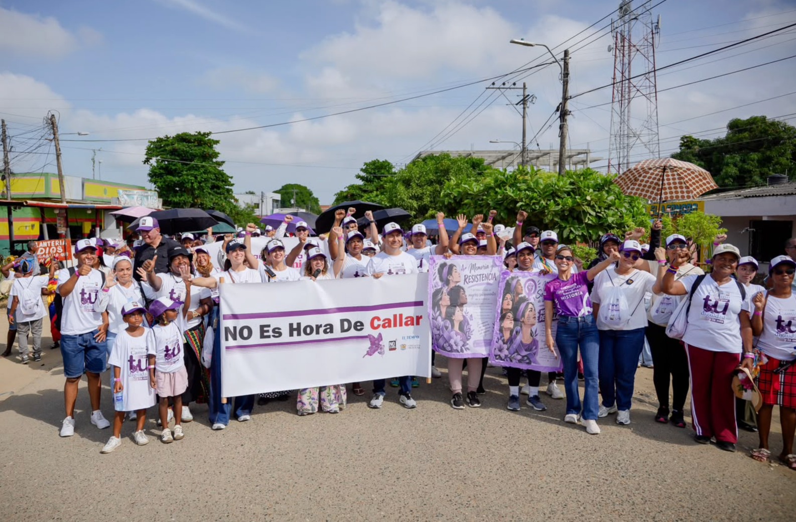 Grupo de mujeres con camisetas blancas y pancartas No es hora de callar durante la caminata.